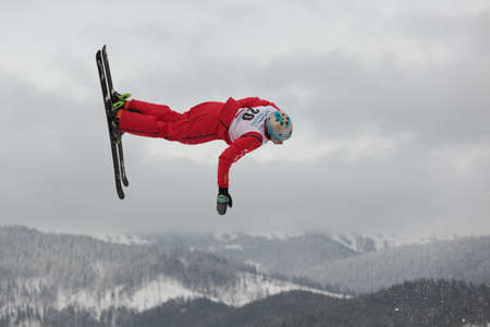 Bukovel, Ukraine - February 23, 2013: Andreas Isoz, Switzerland performs aerial skiing during Freestyle Ski World Cup in Bukovel, Ukraine on February 23, 2013.のeditorial素材