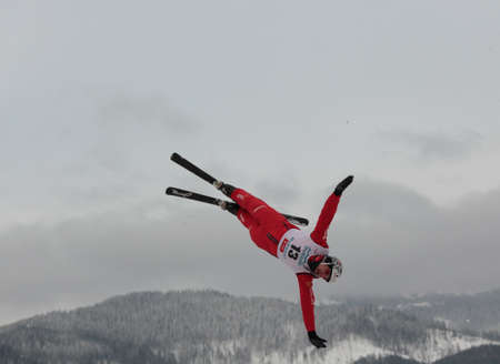 Bukovel, Ukraine - February 23, 2013: Thomas Lambert, Switzerland performs aerial skiing during Freestyle Ski World Cup in Bukovel, Ukraine on February 23, 2013.のeditorial素材