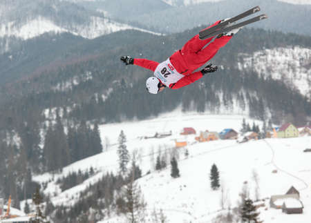 Bukovel, Ukraine - February 23, 2013: Mischa Gasser, Switzerland performs aerial skiing during Freestyle Ski World Cup in Bukovel, Ukraine on February 23, 2013.のeditorial素材