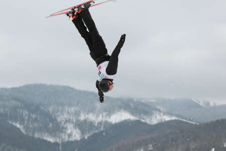 Bukovel, Ukraine - February 23, 2013: Alexei Grishin, Belarus performs aerial skiing during Freestyle Ski World Cup in Bukovel, Ukraine on February 23, 2013.のeditorial素材