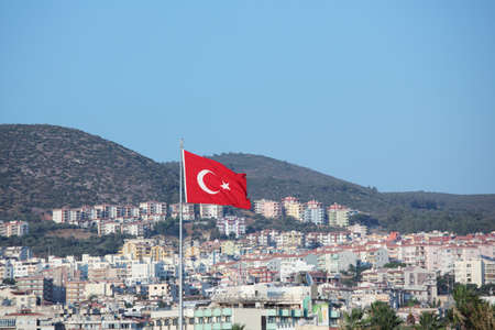 Turkish flag over the city of Kusadasi, Turkeyの写真素材