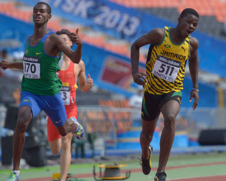 Donetsk, Ukraine - July 14, 2013: Boys compete in the final of 200 metres during 8th IAAF World Youth Championships in Donetsk, Ukraine on July 14, 2013. Left to right: Vitor Hugo dos Santos of Brazil, Youxue Mo of China, Michael O'Hara of Jamaicaのeditorial素材