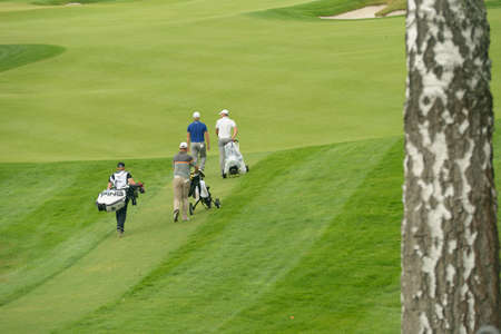Moscow, Russia - July 28, 2013: Golfers go to the hole during final round of the M2M Russian Open at Tseleevo Golf & Polo Club in Moscow, Russia on July 28, 2013のeditorial素材