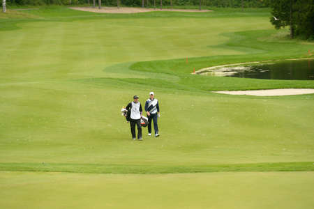Moscow, Russia - July 28, 2013: Soren Hansen of Denmark and his caddie during final round of the M2M Russian Open at Tseleevo Golf & Polo Club in Moscow, Russia on July 28, 2013のeditorial素材