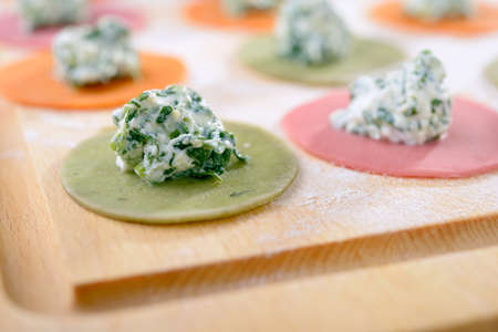 Cooking multi-colored ravioli with spinach and ricottaの写真素材