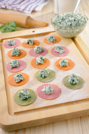 Cooking multi-colored ravioli with spinach and ricottaの写真素材