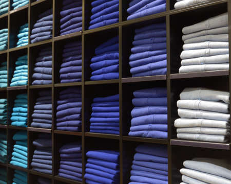 Blue colored clothes on shelves in a shop