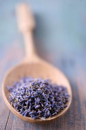 Dried lavender flowers in a bamboo spoon. Selective focusの写真素材