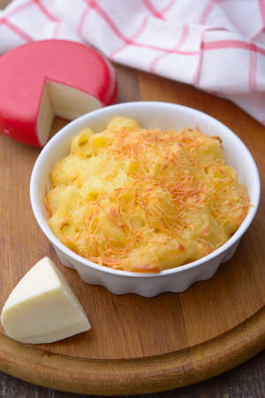 Macaroni and cheese in a baking dish on a cutting board