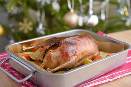 Duck stuffed with apples on a Christmas tableの写真素材