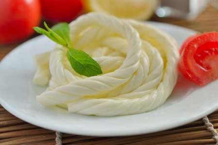 Twisted cheese on a plateの写真素材