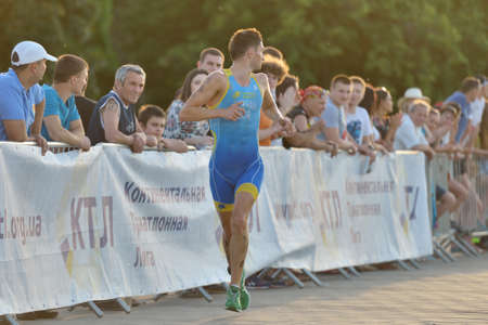 Dnepropetrovsk, Ukraine - May 24, 2014: Sergiy Kokhan of Ukraine runs on the third stage of ETU Sprint Triathlon European cup. It's the first time Triathlon European Cup take place in Ukraineのeditorial素材