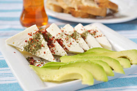 Turkish breakfast with cheese, avocado, spices, and teaの写真素材