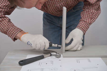 Man assembling the wooden chestの写真素材