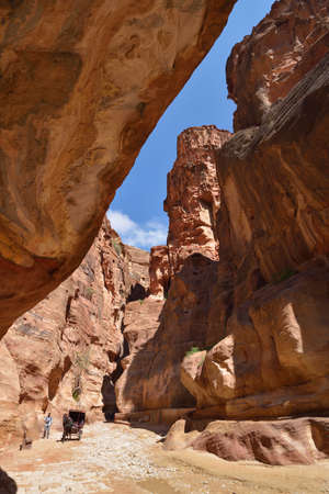 Petra, Jordan - March 15, 2014  Tourist and the two-wheeled carriage in the Siq, the canyon of Petra  Since 1985, Petra is listed as UNESCO World Heritage siteのeditorial素材