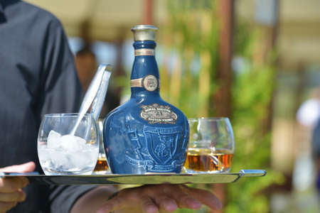Tseleevo, Moscow region, Russia - July 26, 2014  Waiter offers the whiskey Royal Salute to the guests of the British Polo Day  This brand of Scotch whisky produced by Chivas Brothersのeditorial素材