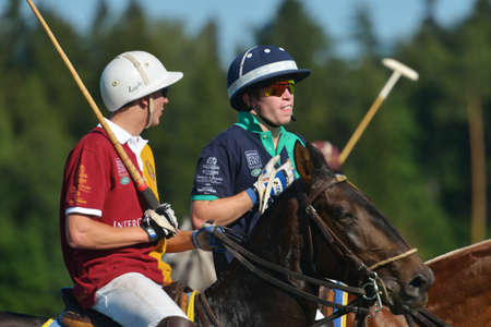 Tseleevo, Moscow region, Russia - July 26, 2014  Sam Browne of Oxbridge Polo Team  right  and Pavel Isayev of Tseleevo Polo Club talking between chukkers during the British Polo Day  Oxbridge won 5-4のeditorial素材