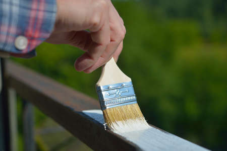 Man painting a guard rail on a balconyの写真素材