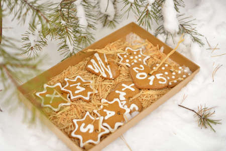 Christmas cookies in a paper box on a snowの写真素材