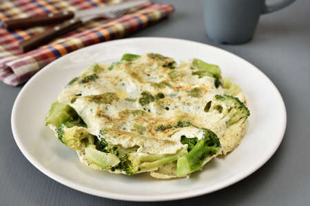 Omelet with broccoli on a plateの写真素材