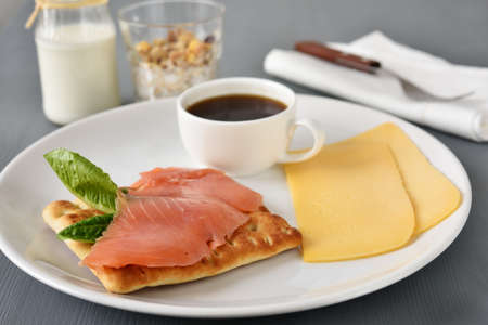 Swedish breakfast with salmon, lettuce, cheese, coffee, muesli, and milkの写真素材