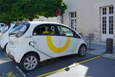 La Rochelle, France - June 24, 2013: Electric car Yelomobile recharging at the charging station....