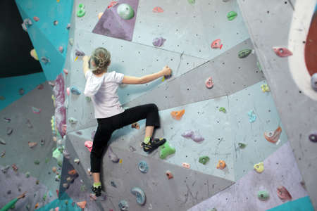 Dnepropetrovsk, Ukraine - April 11, 2015: Girl trains during the open bouldering festival Dnepr...