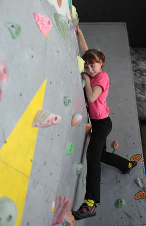 Dnepropetrovsk, Ukraine - April 11, 2015: Girl trains during the open bouldering festival Dnepr Montana Kids. The festival organized by the climbing wall Montana and the local association of extreme sportsのeditorial素材