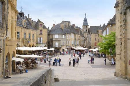 Sarlat, France - June 28, 2013: Tourist walking in the historic center of old city. Since 2002, the old city of Sarlat included in UNESCO Tentative Listのeditorial素材