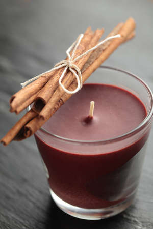 Aromatic candle and cinnamon sticksの写真素材