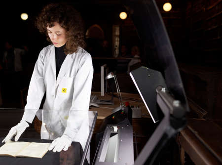 St. Petersburg, Russia - September 16, 2015: Tatiana Tychina from scanning department of Presidential library performs digitization of collection of St. Petersburg State Universitys scientific library. The project aimed to make unique documents availableのeditorial素材