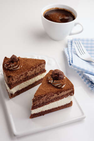 Two slices of chocolate cake and a cup of black coffee