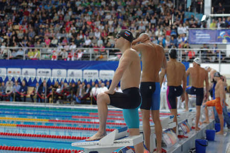 St. Petersburg, Russia - December 16, 2016: Men on the start of 100 m freestyle swimming during X Vladimir Salnikov Cup. Athletes from 6 countries participated in the competitionsのeditorial素材