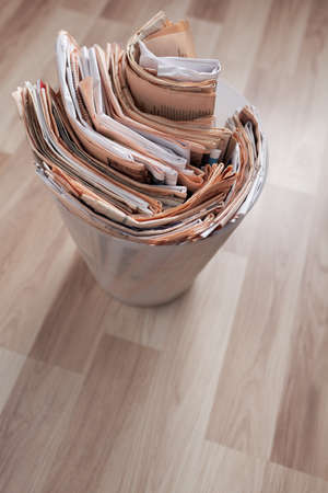 Old newspapers in the overloaded recycle binの写真素材