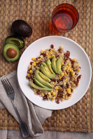 Quinoa and vegetables salad with avocado on a rustic tableの写真素材