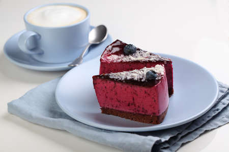 Two slices of fruit cake and a cup of coffee latteの写真素材