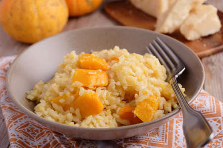 Pumpkin risotto on a rustic tableの写真素材