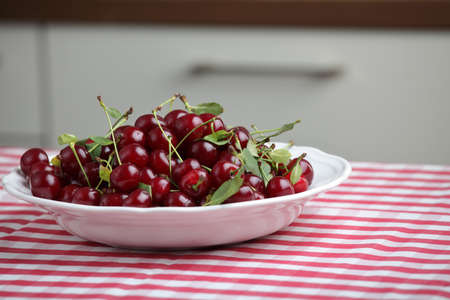 Bowl of sour cherry on a kitchen tableの写真素材