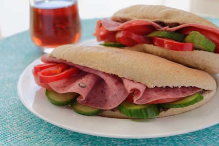 Sandwiches with pita bread, Bologna sausage, and vegetablesの写真素材
