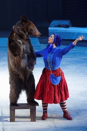 St. Petersburg, Russia - December 28, 2017: Victoria Akimova as Gerda with trained bear in the circus show Snow Queen by Great Moscow circus. The show created by Zapashny brothers circusのeditorial素材