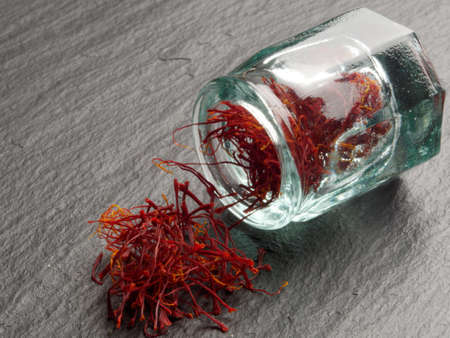 Dried saffron stigmas on slate surface closeup
