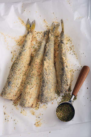 Breaded smelt fish with spices before roastingの写真素材