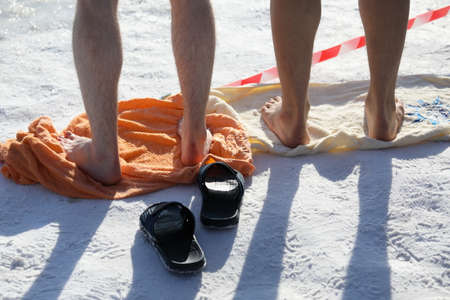 St. Petersburg, Russia - March 4, 2018: Amateur winter swimmer at ice hole during Big Neva Cup. Winter swimmers from 12 countries aged from 12 to 78 take part in the competitions this yearのeditorial素材