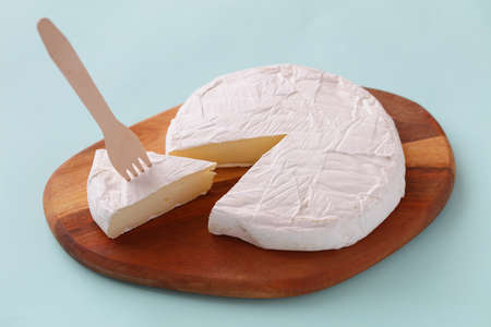 Brie cheese on a wooden cutting board