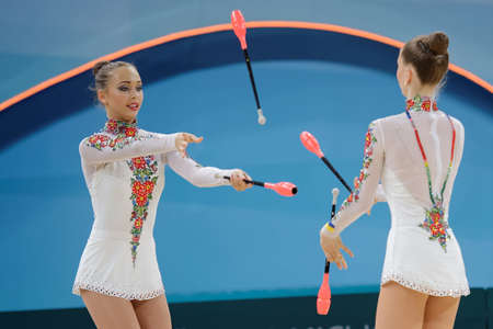 Kiev, Ukraine - August 31, 2013: Team Russia performs with clubs during 32nd Rhythmic Gymnastics World Championships. The event is held in the Palace of Sportsのeditorial素材