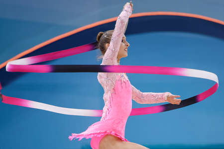 Kiev, Ukraine - August 29, 2013: Unidentified female gymnast performs with ribbon during 32nd Rhythmic Gymnastics World Championships. The event is held in Palace of Sportのeditorial素材