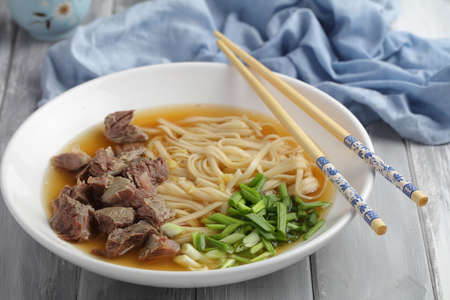 Chinese beef shank noodle soup with green onion