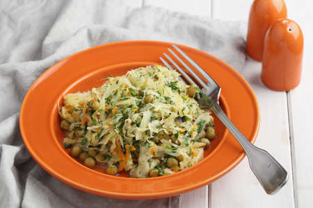 Braised cabbage with green pea, carrot, onion, and dillの写真素材