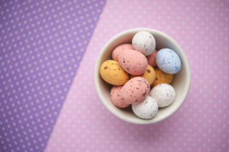 Easter candy egg on colorful backgroundの写真素材