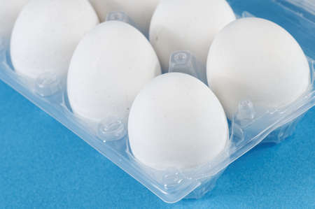 Closeup view of dozen white eggs in a boxの写真素材